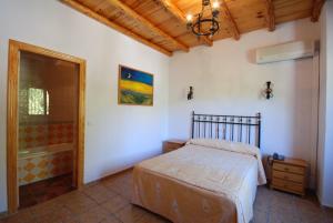 a bedroom with a bed and a walk in shower at Hospedería Río Zumeta Spa in Santiago de la Espada