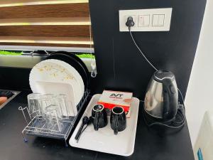 a kitchen counter with a tray with utensils on it at Zerahs Home - 2 Bedroom Villa, Athirappilly in Athirappilly