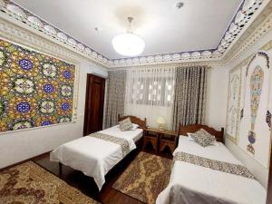 Кровать или кровати в номере Hotel Gulnaraxanum Boutique This hotel is nearby the center of the old city Every room decorated in the unique style