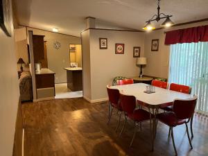 a dining room with a table and red chairs at Eureka Springs Country 4bd 2ba Full House - Enjoy a Country Retreat near Beaver Lake and Dam, the White River and Eureka Springs Area in Eureka Springs