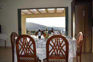 a dining room table with chairs and bottles of wine at Villa Sofia with an amazing view in Angón