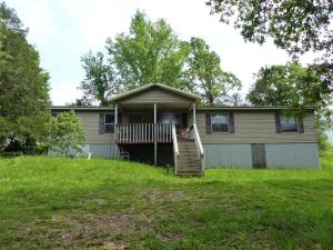 a house with a porch and a staircase in a yard at Eureka Springs Country 4bd 2ba Full House - Enjoy a Country Retreat near Beaver Lake and Dam, the White River and Eureka Springs Area in Eureka Springs