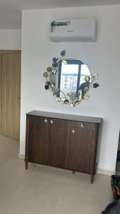 a mirror on top of a dresser in a room at Rmilat Garden N8 vue sur la piscine in Cabo Negro