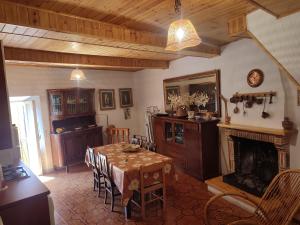 a dining room with a table and a fireplace at Tra cielo e terra in Trevi nel Lazio
