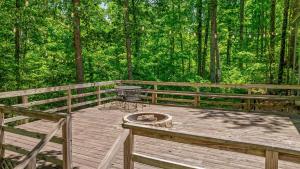 a wooden deck with a grill in the middle of a forest at Happy Glamper RV at Haven of Hope near Little River Canyon National Preserve in Fort Payne +54 photos