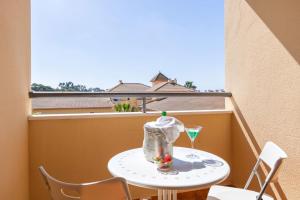 a small table on a balcony with a drink at YOKOI La Antilla in La Antilla