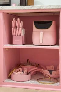 a pink toy kitchen with a pink toaster and other items at Pink Nashville Cottage - Girls' Trip, 12 Min to Broadway in Nashville