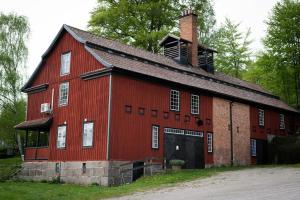 a red barn with a chimney on top of it at Humletorkan Vandrarhem in Näsum +9 photos