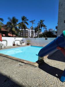 uno scivolo d'acqua di fronte alla piscina di Apartamento para temporada em Cabo Frio a Cabo Frio