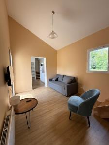 a living room with a couch and a table at Village Vacances de Bretou in Eymet