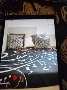 a bed with some pillows on top of it at Maison familiale in Plouzané