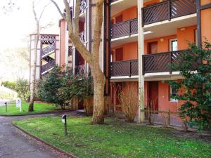 an orange building with a tree in front of it at Maryse in Moliets-et-Maa