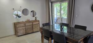 a dining room with a glass table and chairs at l'appart' in Marseille +5 photos