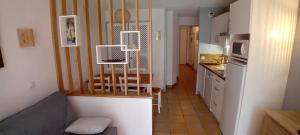 a kitchen with a table and chairs in a room at Maryse in Moliets-et-Maa