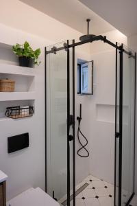 a shower with a glass door in a bathroom at Olivia Flat 1 in Kalamata
