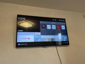 a flat screen tv hanging on a wall at Superking bedroom near James cook hospital in Middlesbrough