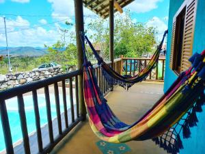 a couple of hammocks hanging on a porch at Pousada Contos da Lua Vaga in Milho Verde