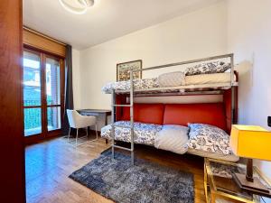 a room with two bunk beds and a table at Spacious 2-Bedroom Apartment with Large Terrace in Milan