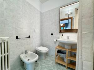 a bathroom with a sink and a toilet and a mirror at Spacious 2-Bedroom Apartment with Large Terrace in Milan +19 photos