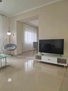 a living room with a large flat screen tv at Samos Endless Blue in Samos