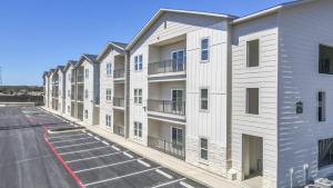 an apartment building with balconies and a parking lot at Brand NEW Oasis Mins from Town in Boerne