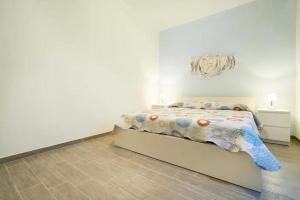 Un ou plusieurs lits dans un hébergement de l'établissement Talia Ortigia Apartment