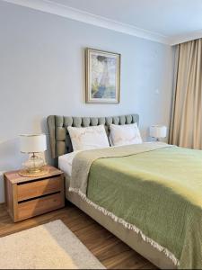 a bedroom with a bed and a table with a lamp at Kaira Homes 2 in Dikmen +38 photos