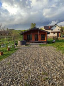 a house on a gravel road in front of a house at Family House Volosianka in Volosyanka