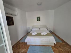 a bedroom with a bed with two towels on it at Holiday Home Marija in Biograd na Moru