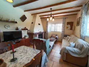 a living room with a couch and a table at Casa Lo Pinto Private Pool Villa South of El Torcal -UNESCO- in La Joya