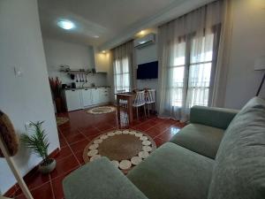 a living room with a couch and a table in it at Seaside Athos I in Ouranoupoli