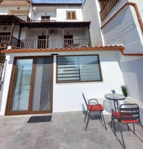 a patio with chairs and a table in front of a house at Seaside Athos I in Ouranoupoli