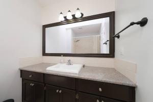 a bathroom with a sink and a mirror at Surrey Family Home w/ Patio & Garden – 3BR 2BA in Guildford +43 photos