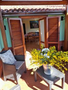 a patio with a table and chairs and flowers at Appartamento Rosanna in Spoleto