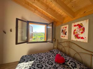 a bedroom with a bed with a red heart on it at La casa di Alice - Casa Natura in Senigallia