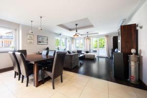 a dining room and living room with a table and chairs at Baltic Breeze Lodge in Gdynia