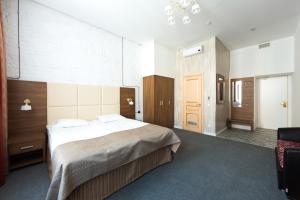 a hotel room with a bed and a chair at Talisman Gorokhovaya in Saint Petersburg