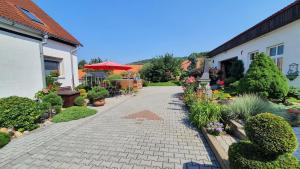 a garden with a brick walkway next to a house at Complete living with a garden in Mochtín