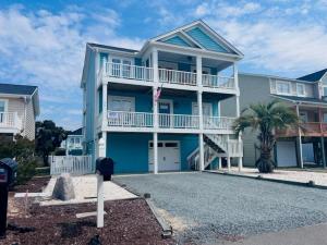 a blue house with a parking meter in front of it at 218 Brunswick home in Holden Beach