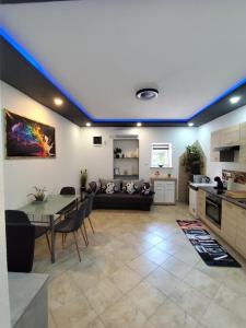 a kitchen and living room with a table and a couch at apartman Goga with pool and jacuzzi in Labin