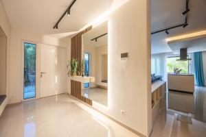 a hallway of a house with a large mirror at Villa PUNTA DURA in Vir +23 photos