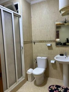 a bathroom with a toilet and a sink at Apartmentos Al Wahda - Oulad Mimoun - Nador in Nador