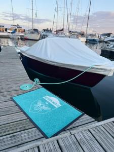 a boat tied to a dock with a sign on it at Sopot Classic Boat in Sopot