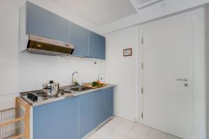 a kitchen with blue cabinets and a sink at Residenza Lago D'Argento - Happy Rentals in Riva del Garda