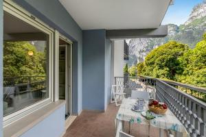 a balcony with a table and a view of the mountains at Residenza Lago D'Argento - Happy Rentals in Riva del Garda +24 photos