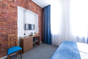 a bedroom with a bed and a brick wall at Talisman Gorokhovaya in Saint Petersburg