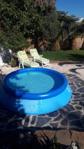 a blue frisbee in front of a swimming pool at Casa La Vega in Torrox Costa