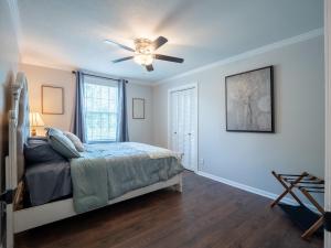 a bedroom with a bed and a ceiling fan at Luxury At Meadowbrook, Pool Home, Fire Pit, Fort in Valdosta +33 photos