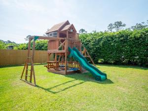 a playground with a slide in a yard at Luxury At Meadowbrook, Pool Home, Fire Pit, Fort in Valdosta