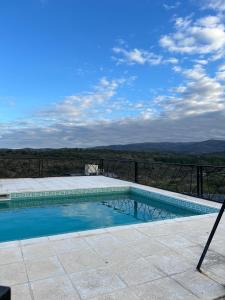 a swimming pool with a view of the mountains at Cabañas La vista in Cavalango
